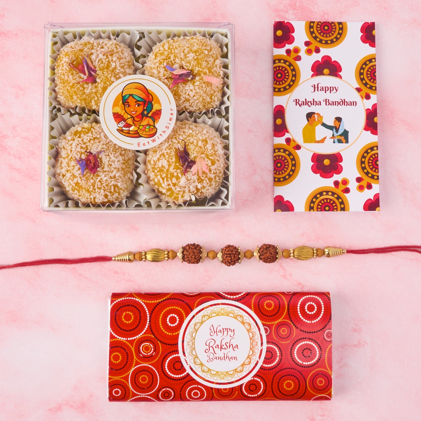 Complete Rakhi gift pack with mango coconut laddoos, Rudraksha Rakhi, Happy Rakhi chocolate bar, message card, and roli chawal – neatly packed in a festive box