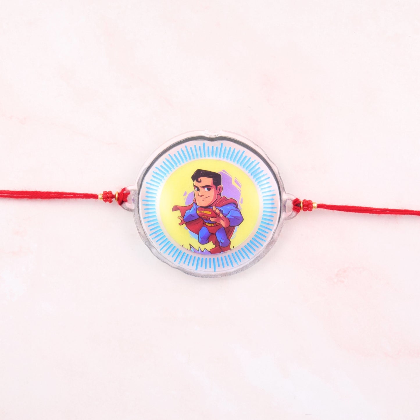 Superman Rakhi for kids with red thread and superhero badge – kids rakhi online