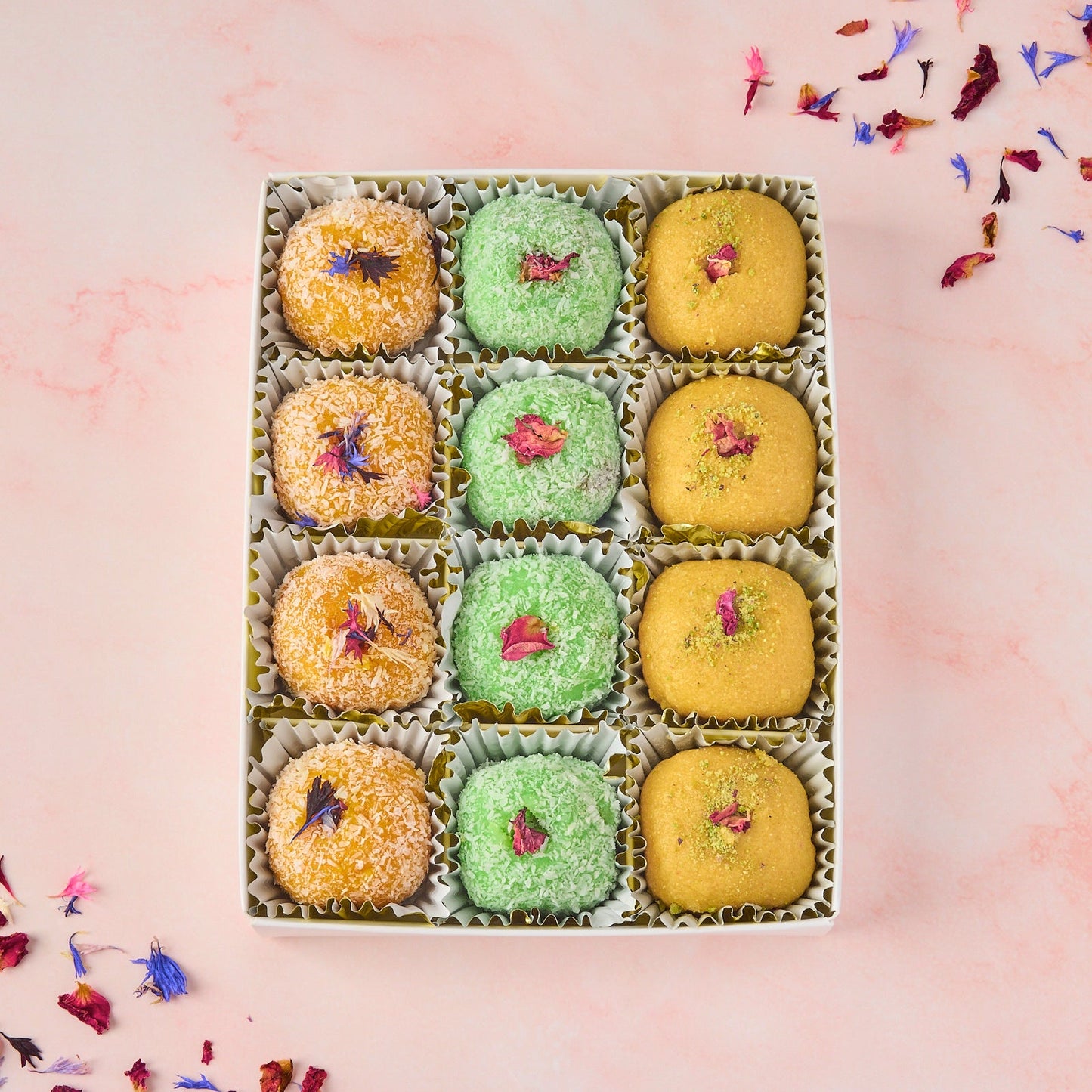 Assorted laddoo gift box with 12 Indian laddoos arranged in a transparent lid box - mixed besan, mango coconut and rose gulkand coconut laddoos for gifting in Australia