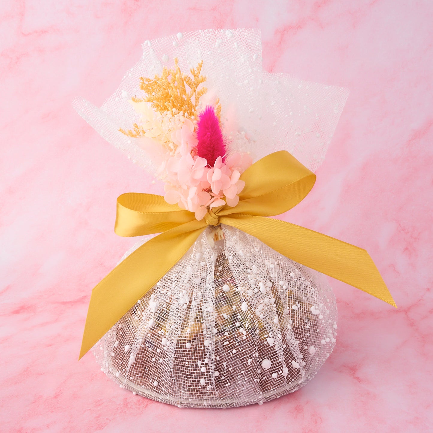 Eggless Cake gift wrapped in decorative net wrap with ribbon by EatWithSimer