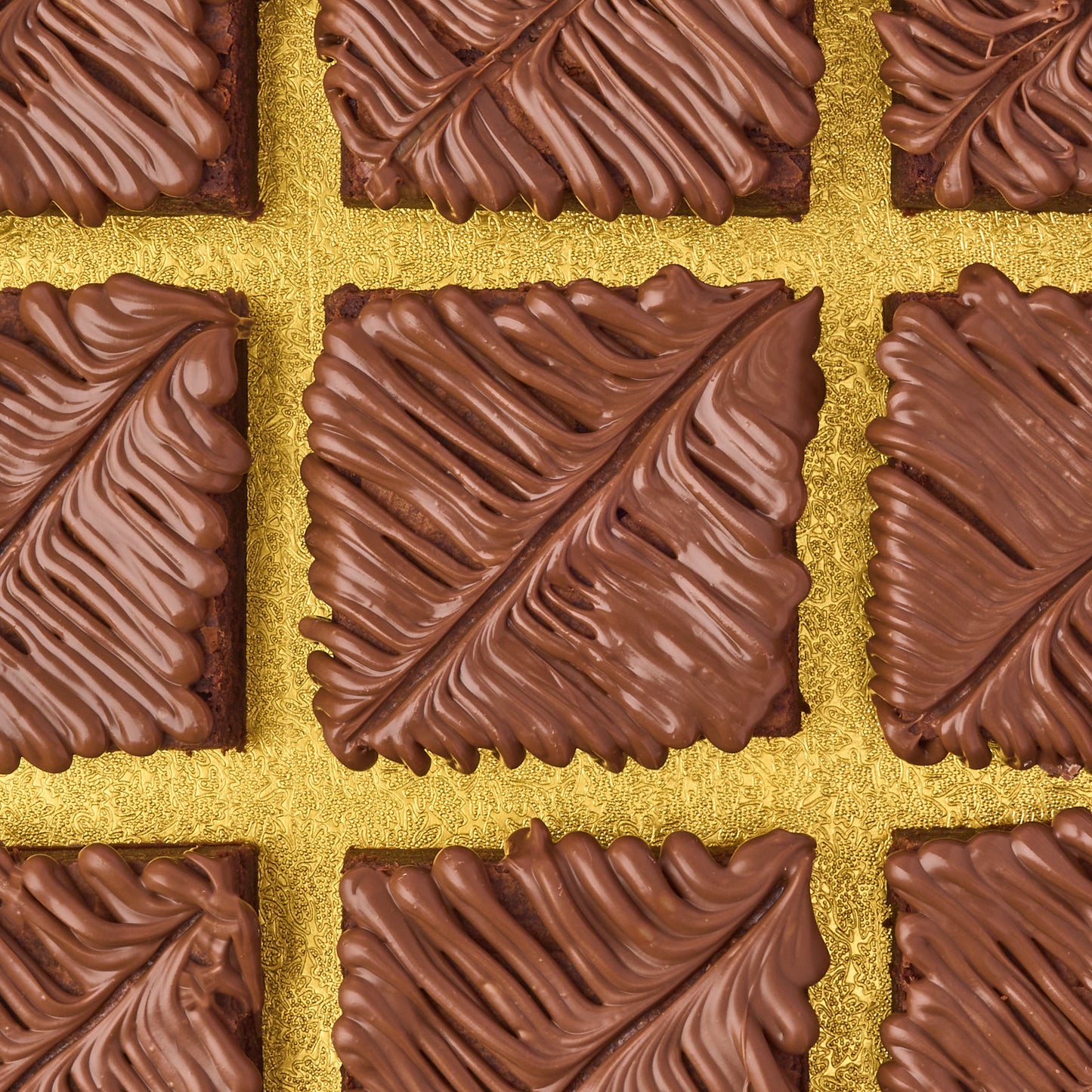 Close-up of eggless chocolate brownies topped with smooth milk chocolate, made using real Belgian couverture chocolate