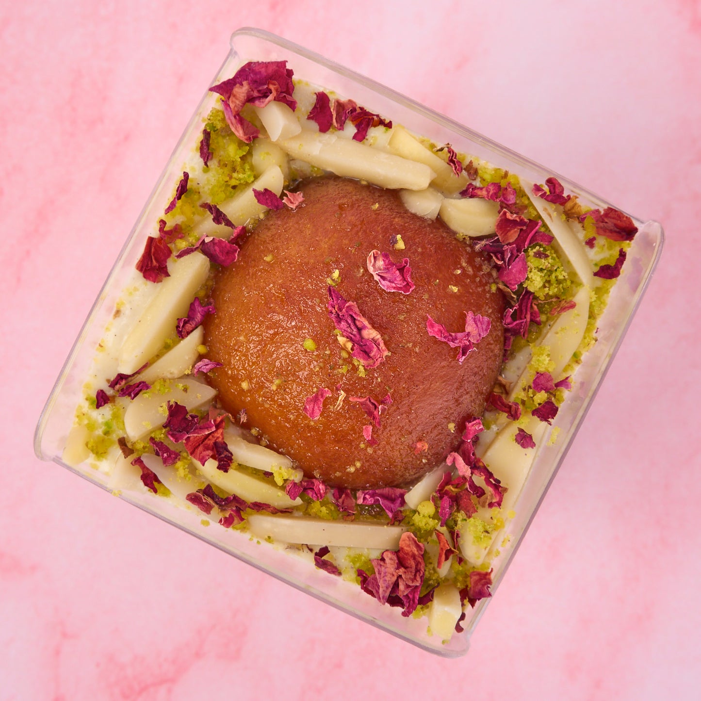 Top view of Gulab Jamun Rabdi Mousse Cup with slivered nuts and rose petal garnish