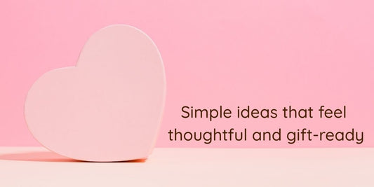 Soft pink Valentine-themed background with a heart shape, used as a blog hero image for a Valentine gift hamper guide