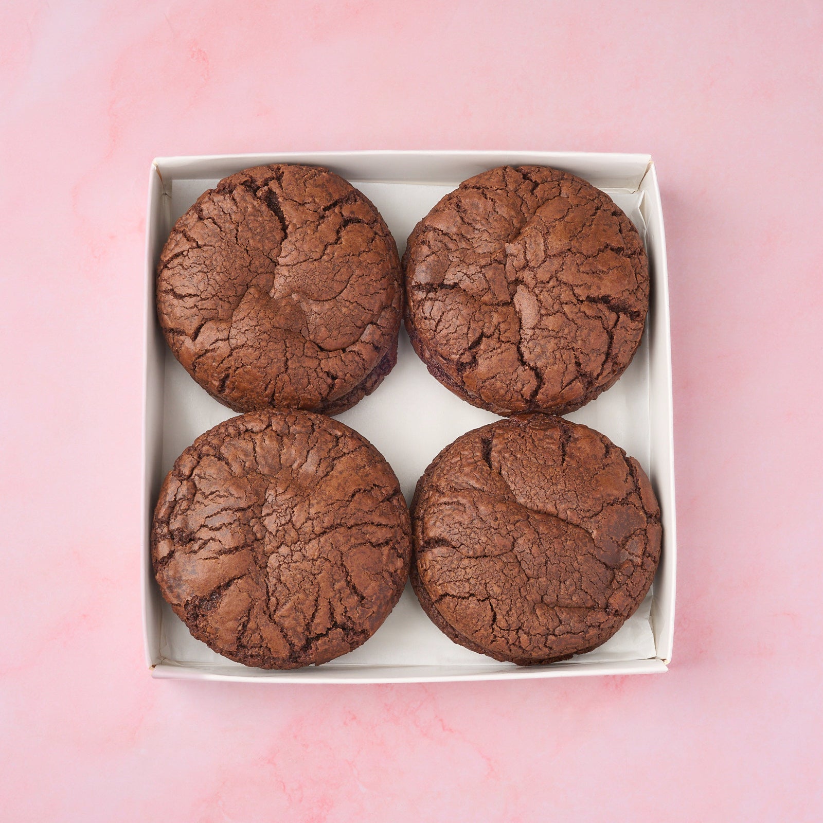 Soft and fudgy brownie cookies arranged neatly in a box
