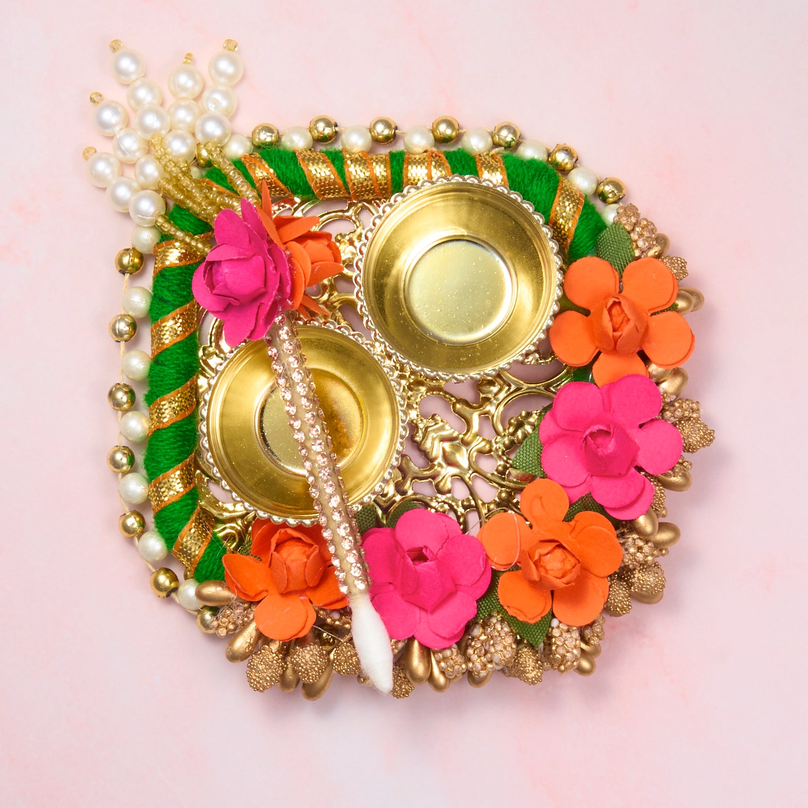 Compact floral roli chawal plate with tika stick. 2 holders for haldi, kumkum or rice – ideal for Rakhi, Diwali or pooja rituals, approx. 9cm wide