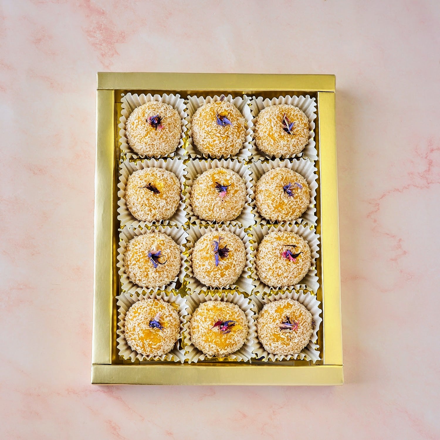 Box of 12 Mango Coconut Laddoos rolled in coconut with edible flower garnish – Indian sweets gift Australia-wide delivery