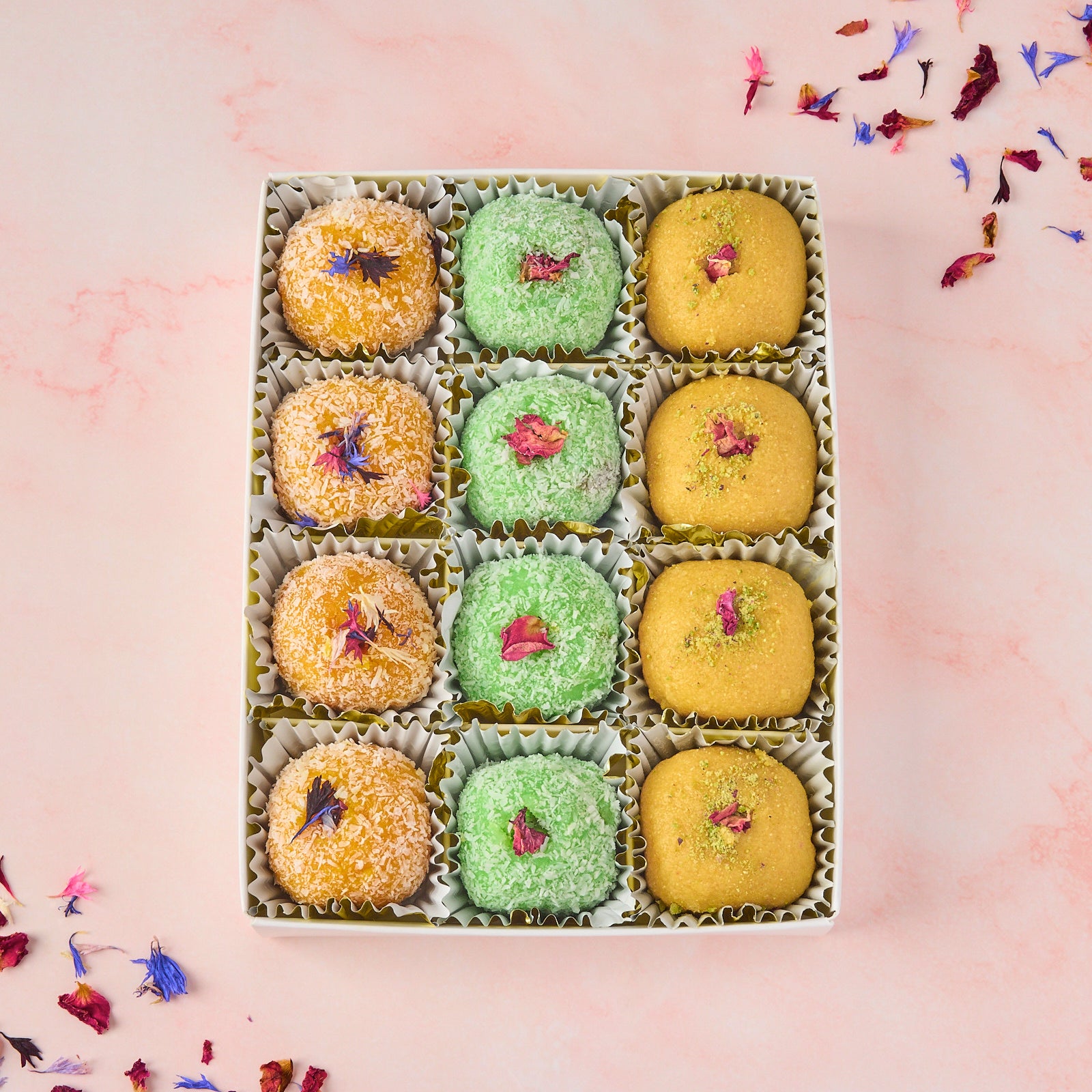 Assorted laddoo gift box with 12 Indian laddoos arranged in a transparent lid box - mixed besan, mango coconut and rose gulkand coconut laddoos for gifting in Australia
