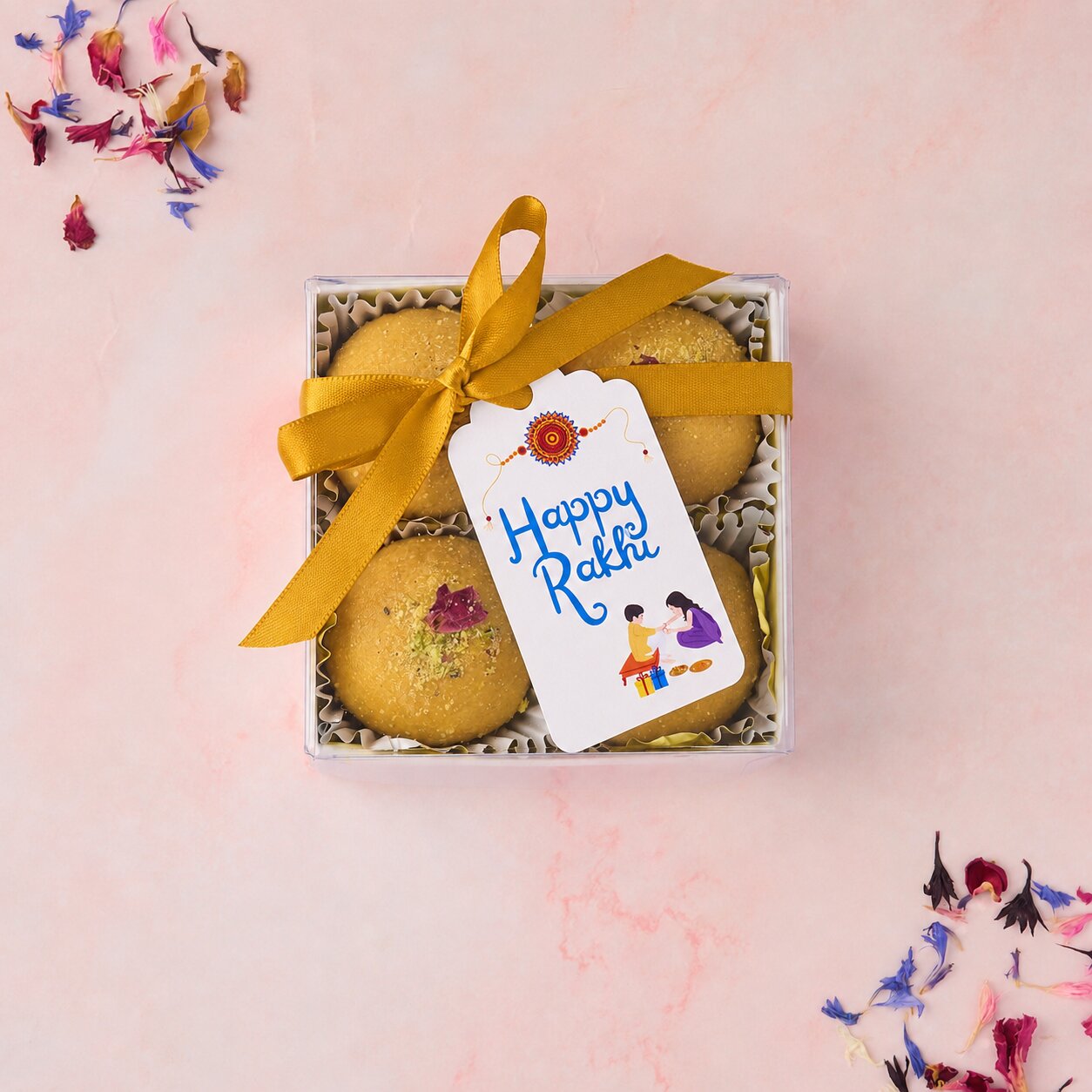 Besan Laddoo 4 Pc Box with gold-coloured ribbon and Happy Rakhi tag