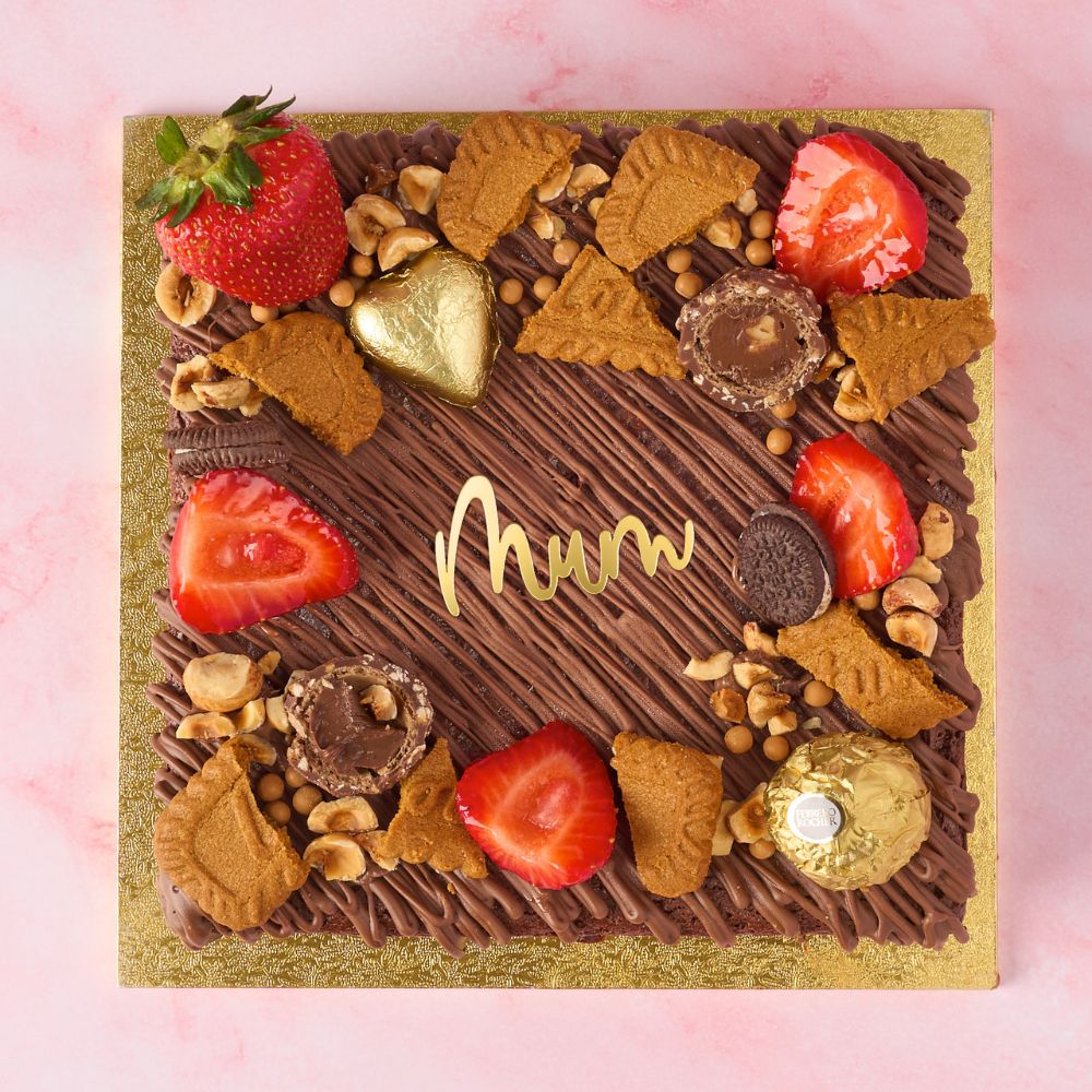 Eggless brownie cake made with Belgian chocolate, decorated with strawberries, Biscoff, Ferrero Rocher and Mum cake charm for Mothers Day Gift