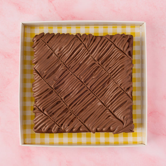 Eggless chocolate brownie slab made with real Belgian chocolate, shown sliced in an open box