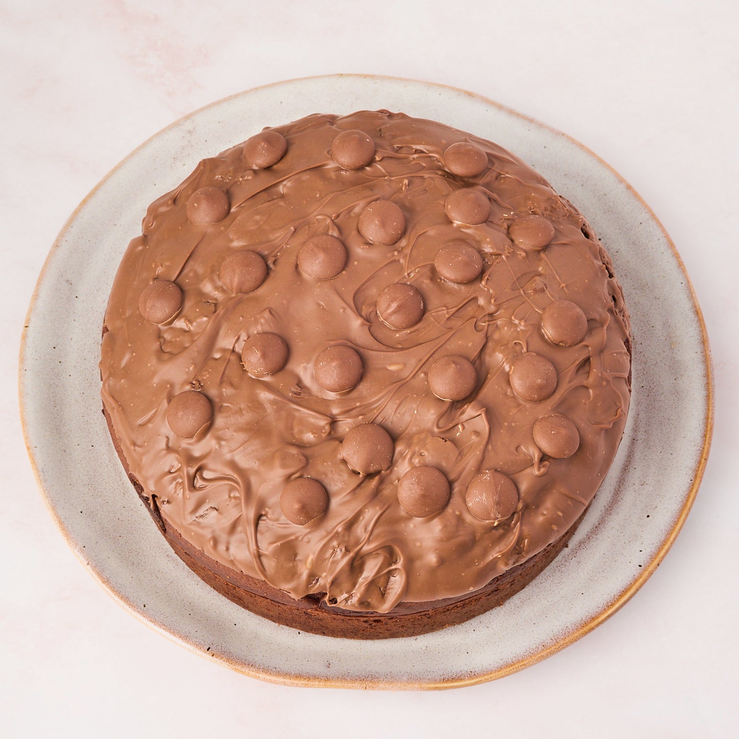 Eggless chocolate cake with milk chocolate topping, top view
