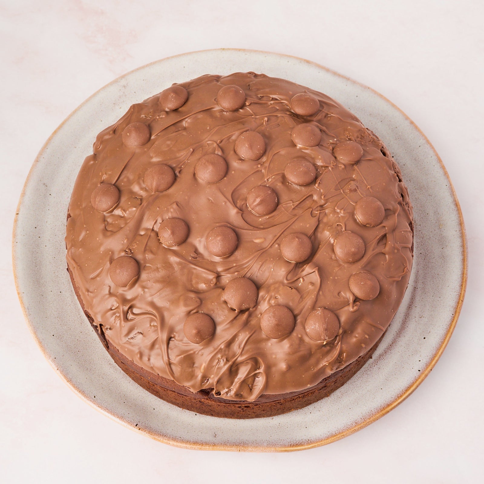 Eggless chocolate cake with milk chocolate topping, top view