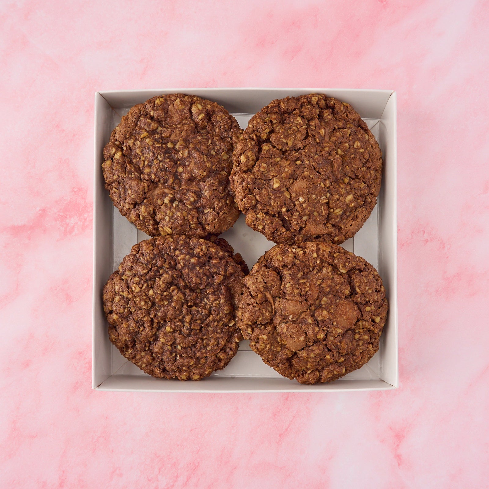 Eggless chocolate oat cookies with a soft, chewy texture packed in a gift box