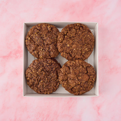 Eggless chocolate oat cookies with a soft, chewy texture packed in a gift box