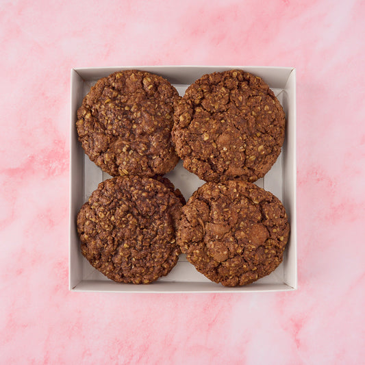 Eggless chocolate oat cookies with a soft, chewy texture packed in a gift box
