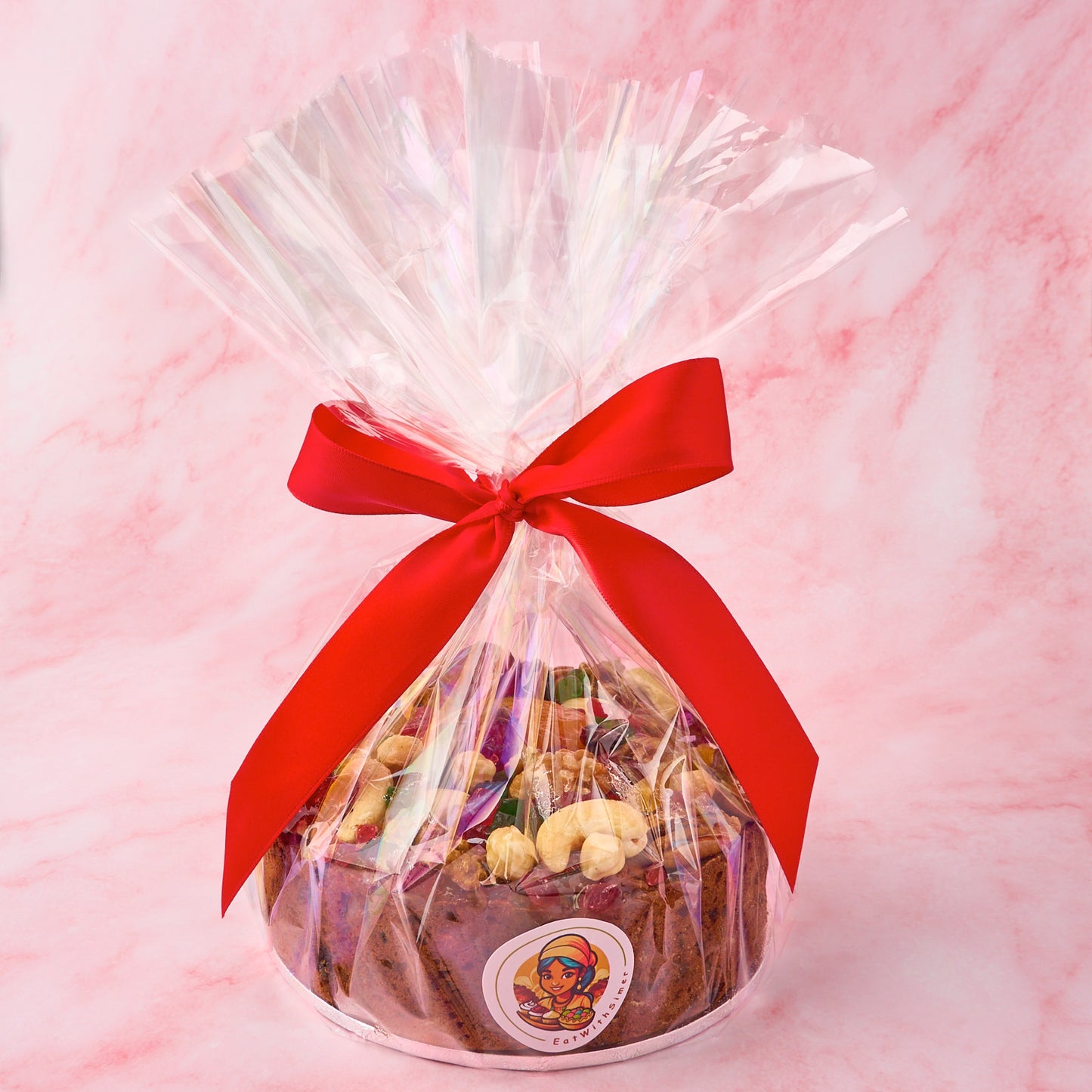 Christmas fruit cake packed in clear gift wrap with festive ribbon for gifting in Sydney.