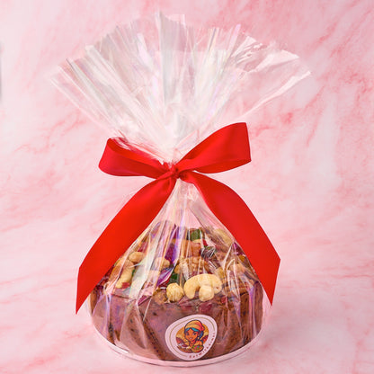 Christmas fruit cake packed in clear gift wrap with festive ribbon for gifting in Sydney.