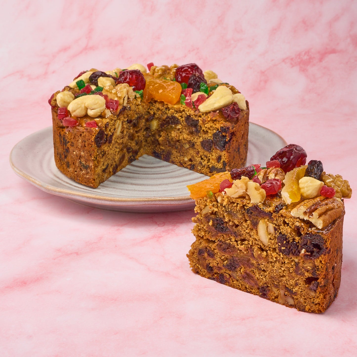 Rich Christmas fruit cake with dense fruit-and-nut interior and plum cake texture, sliced for display