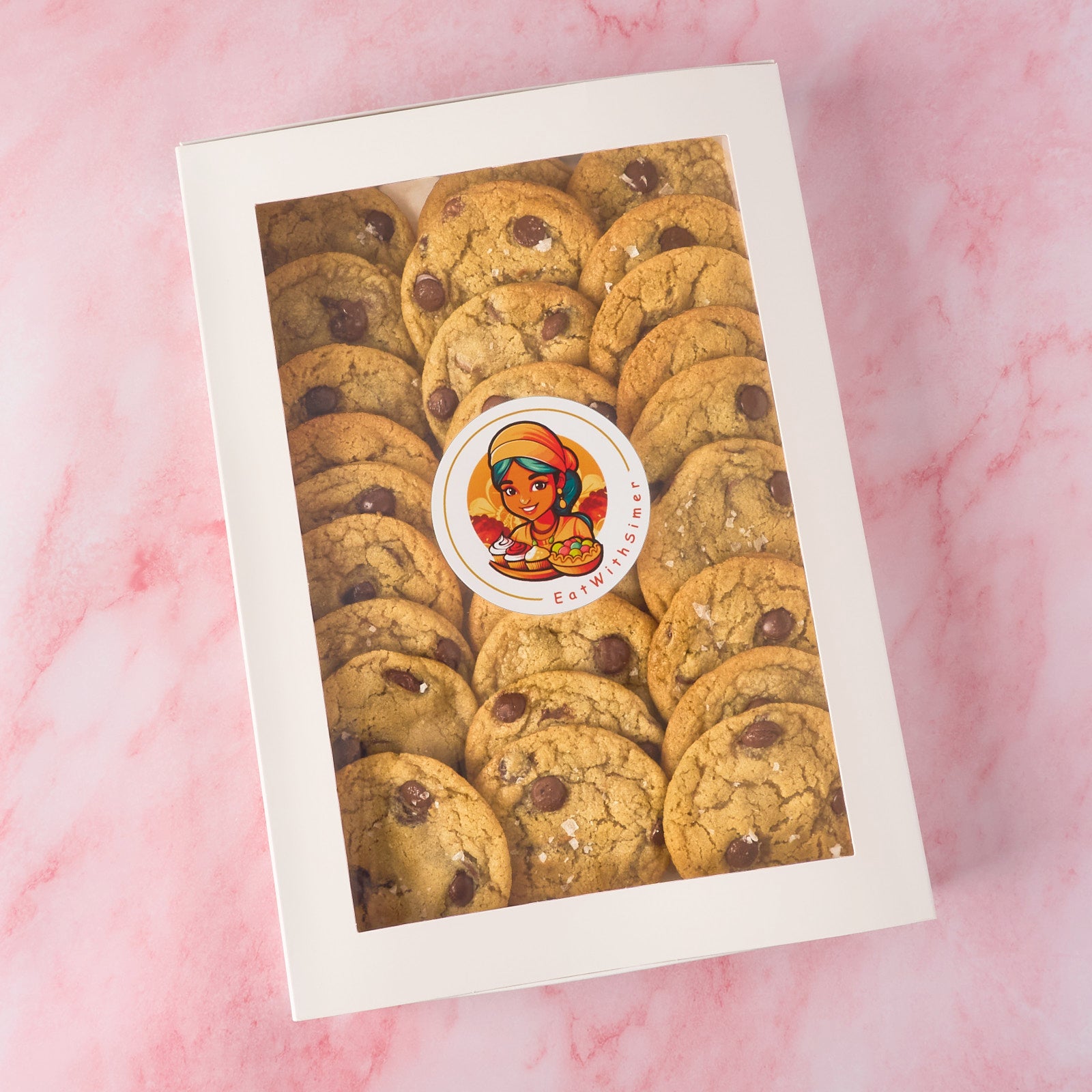 Boxed eggless choco chip cookies made using dark couverture chocolate, available in 27 pc box