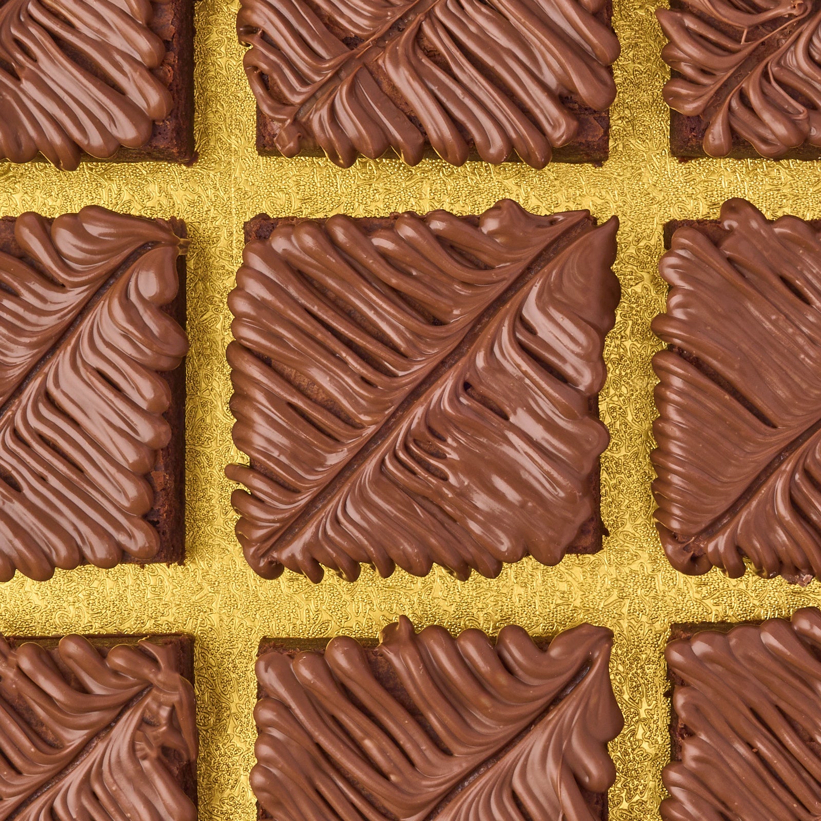 Close-up of eggless chocolate brownies topped with smooth milk chocolate, made using real Belgian couverture chocolate