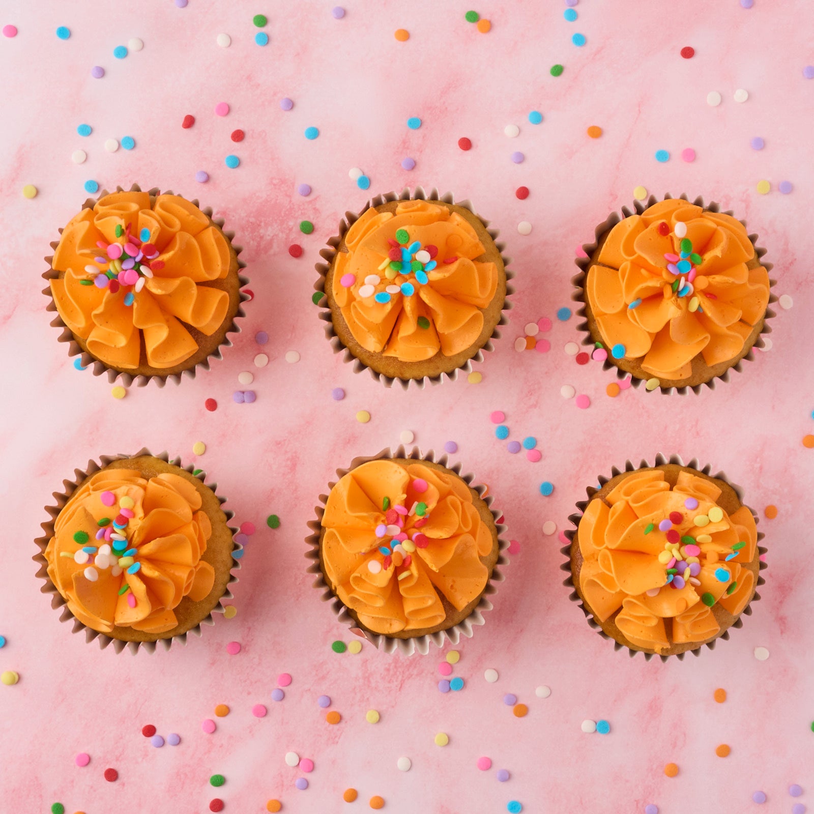 Eggless vanilla cupcakes topped with real buttercream and sprinkles, baked fresh in Sydney