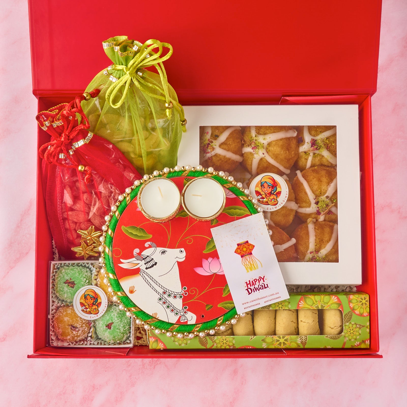 Gauhar Diwali gift hamper with Mini Gulab Jamun Cakes, nankhatai, laddoos, nuts, potli bags and tealight holder