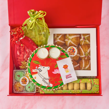 Gauhar Diwali gift hamper with Mini Gulab Jamun Cakes, nankhatai, laddoos, nuts, potli bags and tealight holder
