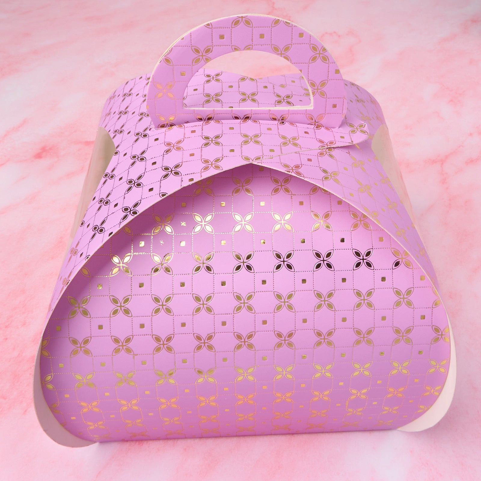 Purple gift cake box with clear window sides and sturdy handle, closed view