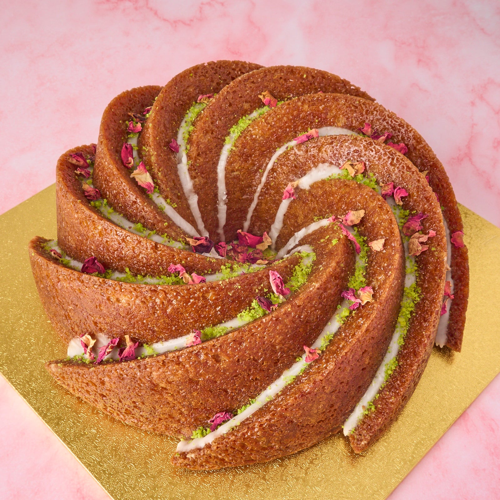 Gulab Jamun Cake in Sydney with spiral design, pistachio and rose petals, modern Indian sweet cake and eggless celebration cake