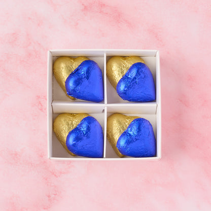 Open blue and gold heart chocolate box showing 8 heart-shaped chocolates, chocolate gift box ideal for baby boy showers, newborn gifting and hampers