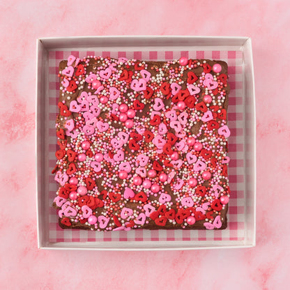 Heart-themed brownie gift box with eggless Belgian chocolate brownie slab decorated with pink and red heart sprinkles