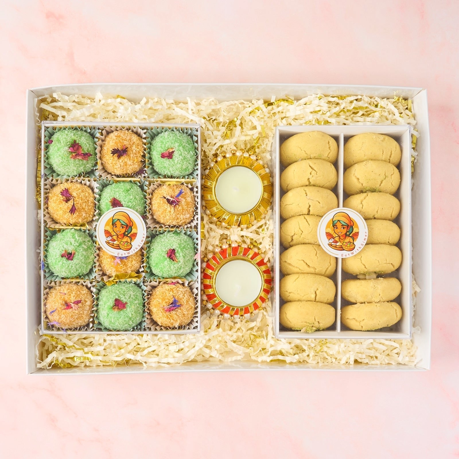 Indian sweets and cookies gift box with laddoos, nankhatai biscuits and decorative tealight holders