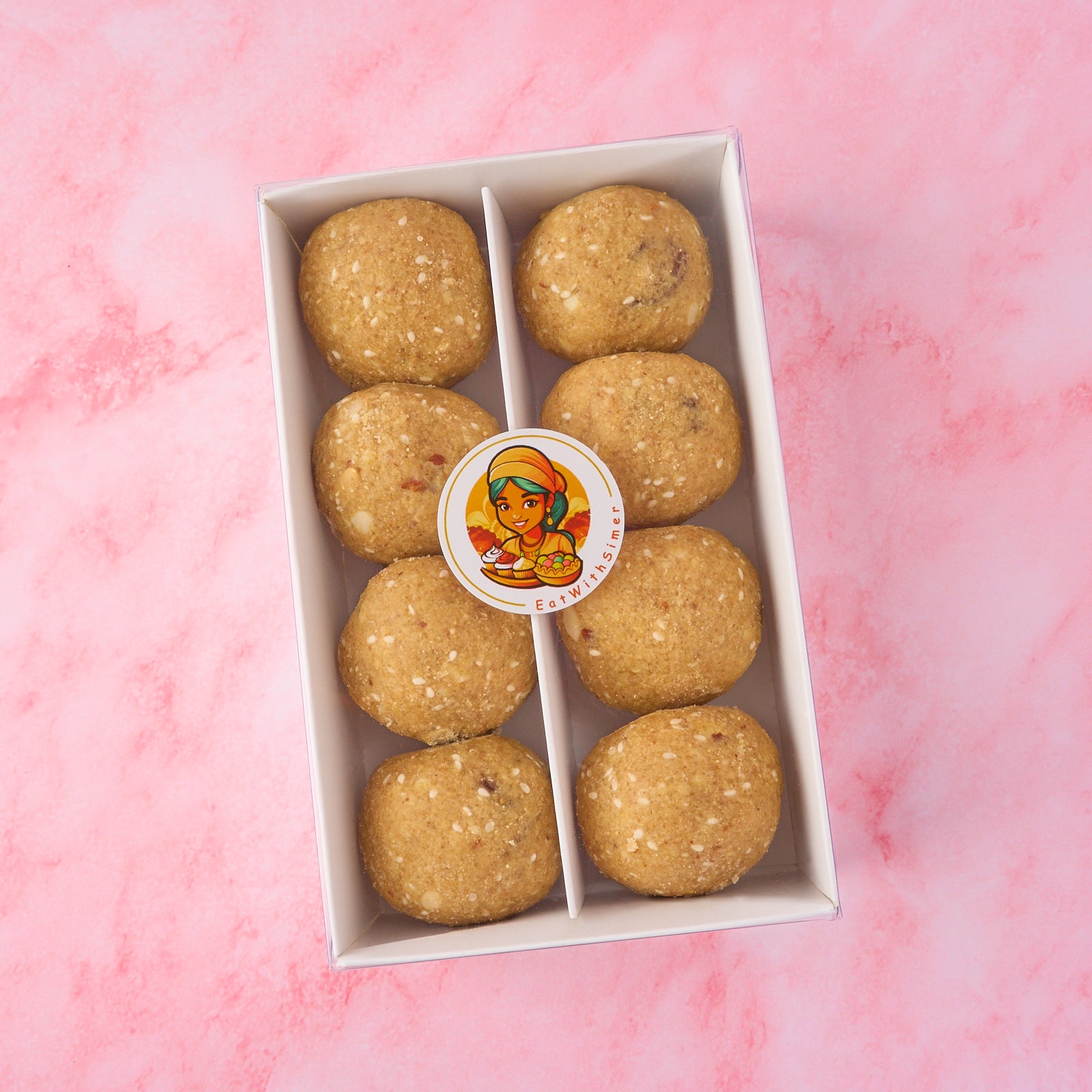 Khoya and dry fruit pinni arranged in a traditional Punjabi atta pinni box made with desi ghee and nuts