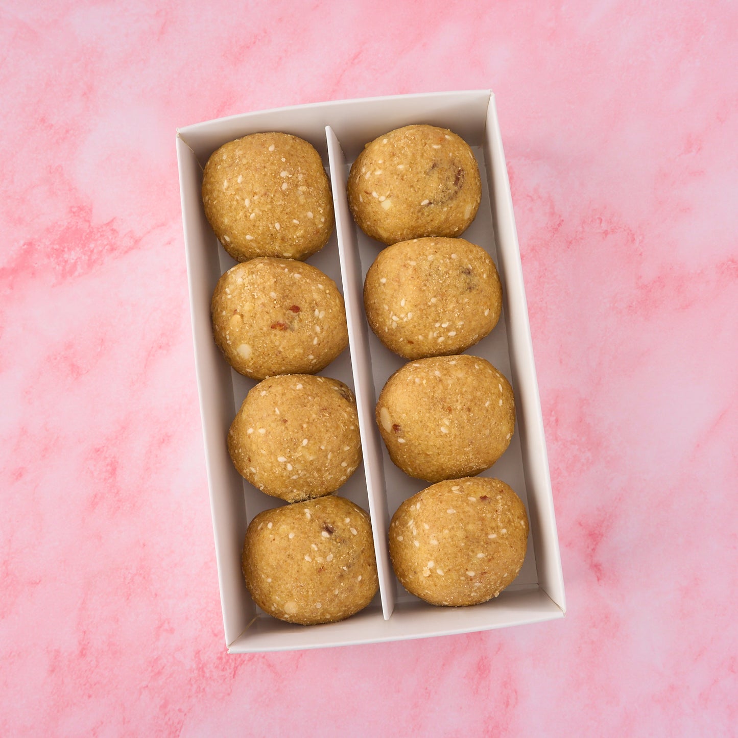 Top view of traditional khoya dry fruit pinni box showing Punjabi style atta pinni with visible nuts