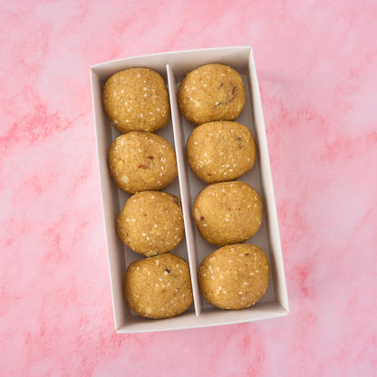 Top view of traditional khoya dry fruit pinni box showing Punjabi style atta pinni with visible nuts