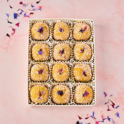 Mango Coconut Laddoo 12 piece gift box with dried flower decoration and transparent lid, premium sweet gifting in Australia