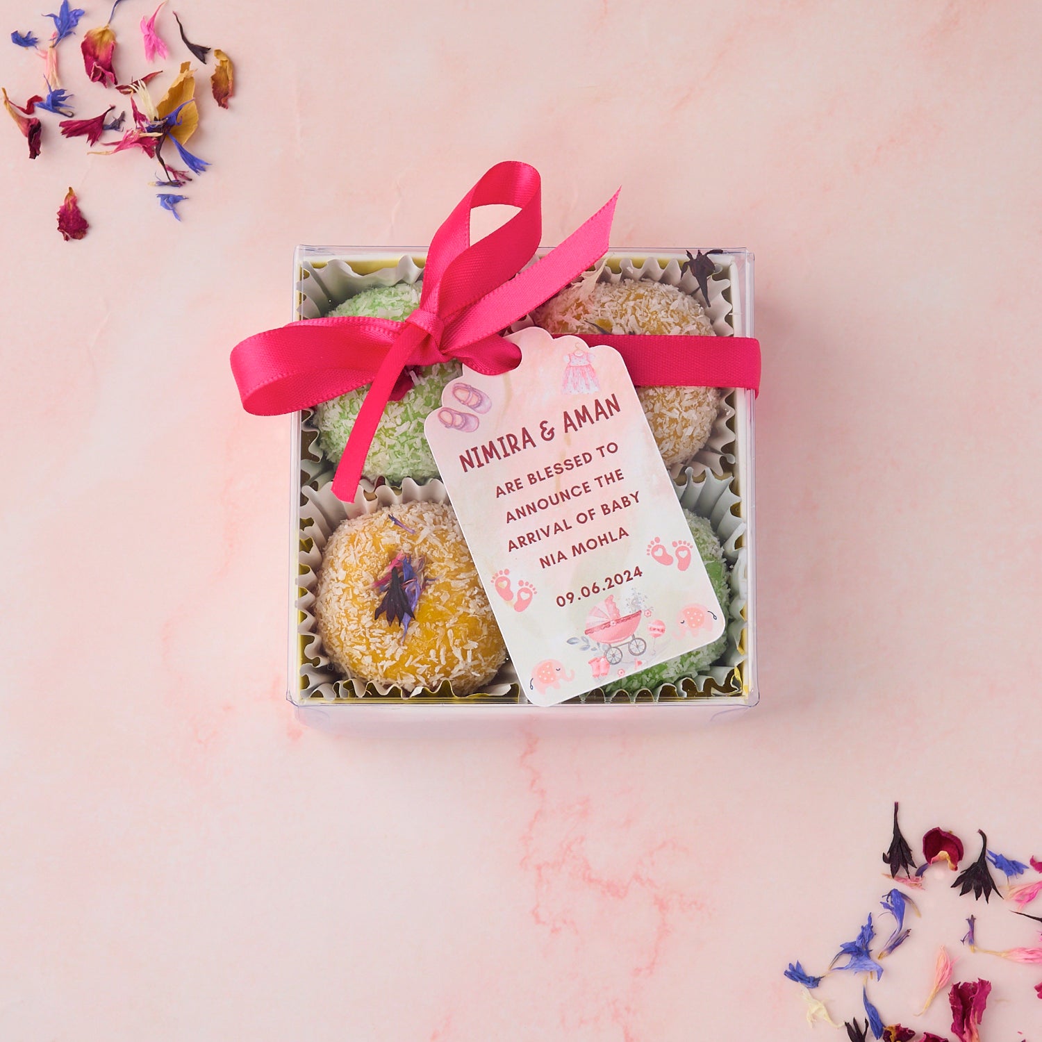 Mango coconut and rose gulkand coconut laddoo return gift box with ribbon and gift tag styled for wedding baby shower and housewarming guest gifting