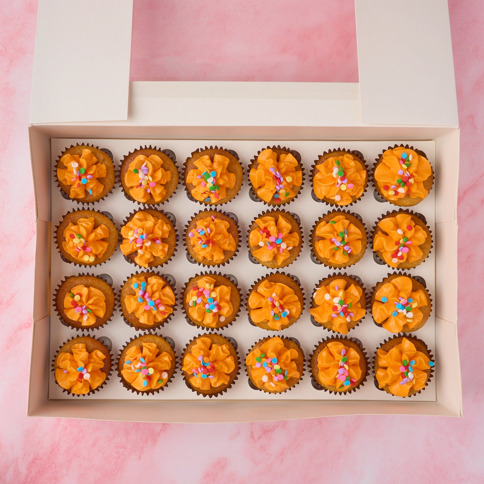 Mini eggless cupcakes in a 24 piece box topped with vanilla buttercream and sprinkles, packed for Sydney delivery or Eastwood pickup