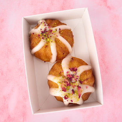 Two eggless mini gulab jamun cakes in a white favour box topped with rose petals and pistachios, Indian dessert return gift for weddings and celebrations in Australia