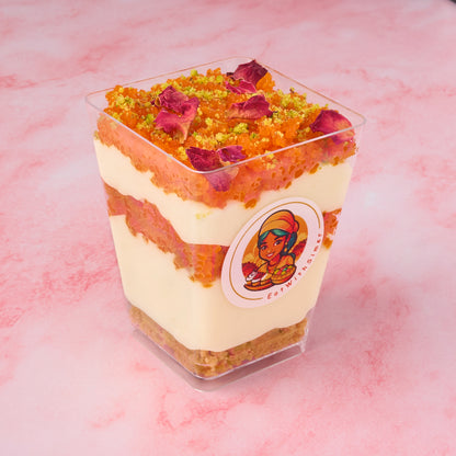 Layered Motichoor Cheesecake Mousse Cup showing biscuit base, cheesecake mousse and motichoor laddoo layer