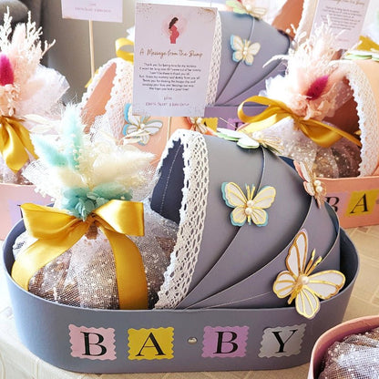 Blue new baby bassinet gift hamper with eggless Pistachio Mawa Cake and personalised message card
