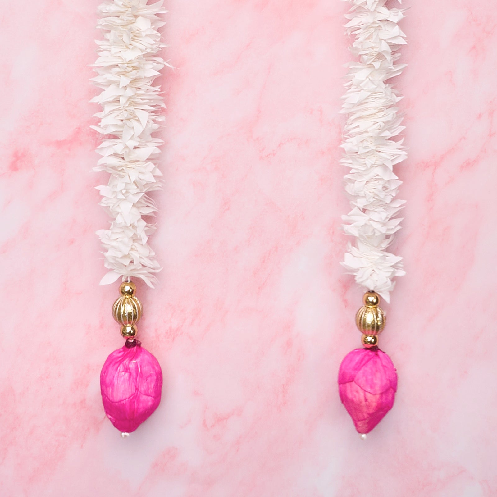 Pink lotus bud wall hangings with white floral garland details