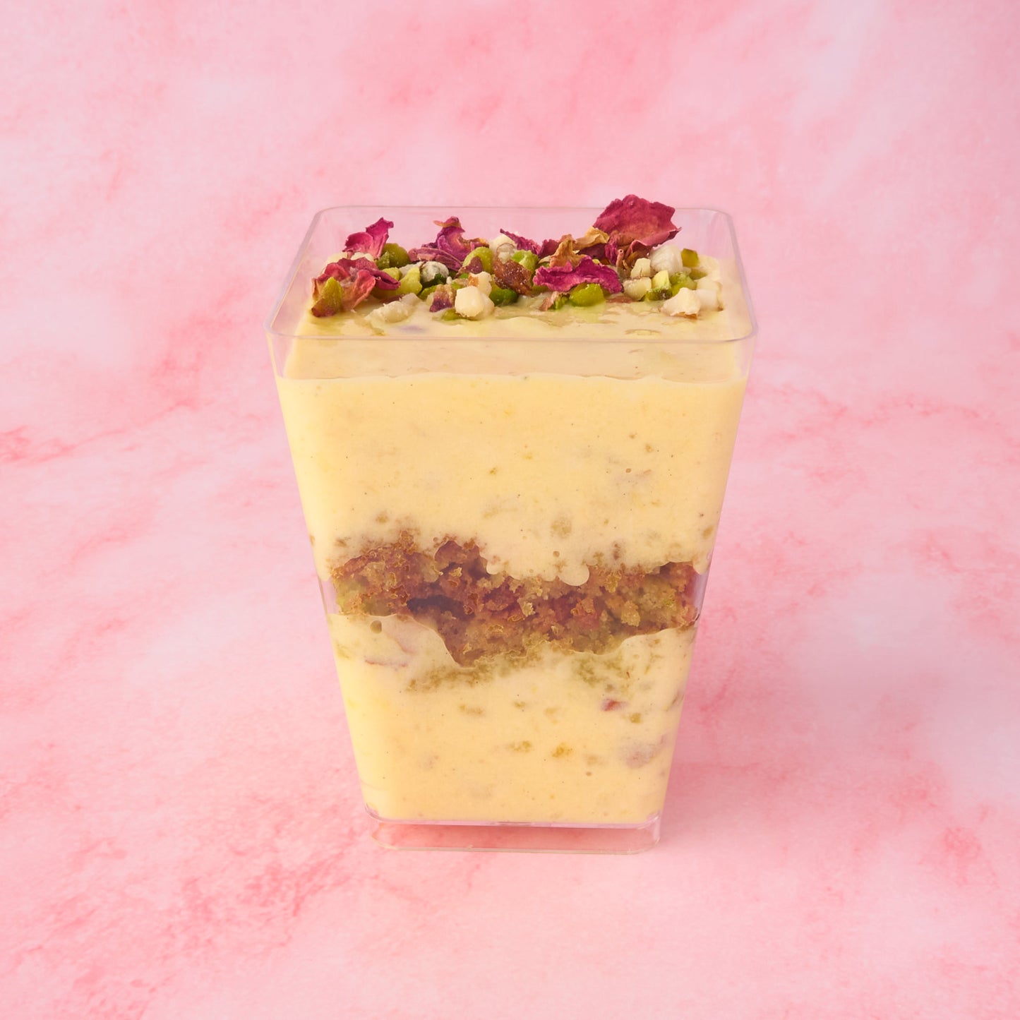 Layered Pistachio Kheer Trifle Cup in Sydney with visible rice pudding and pistachio cake crumble layers in clear dessert cup