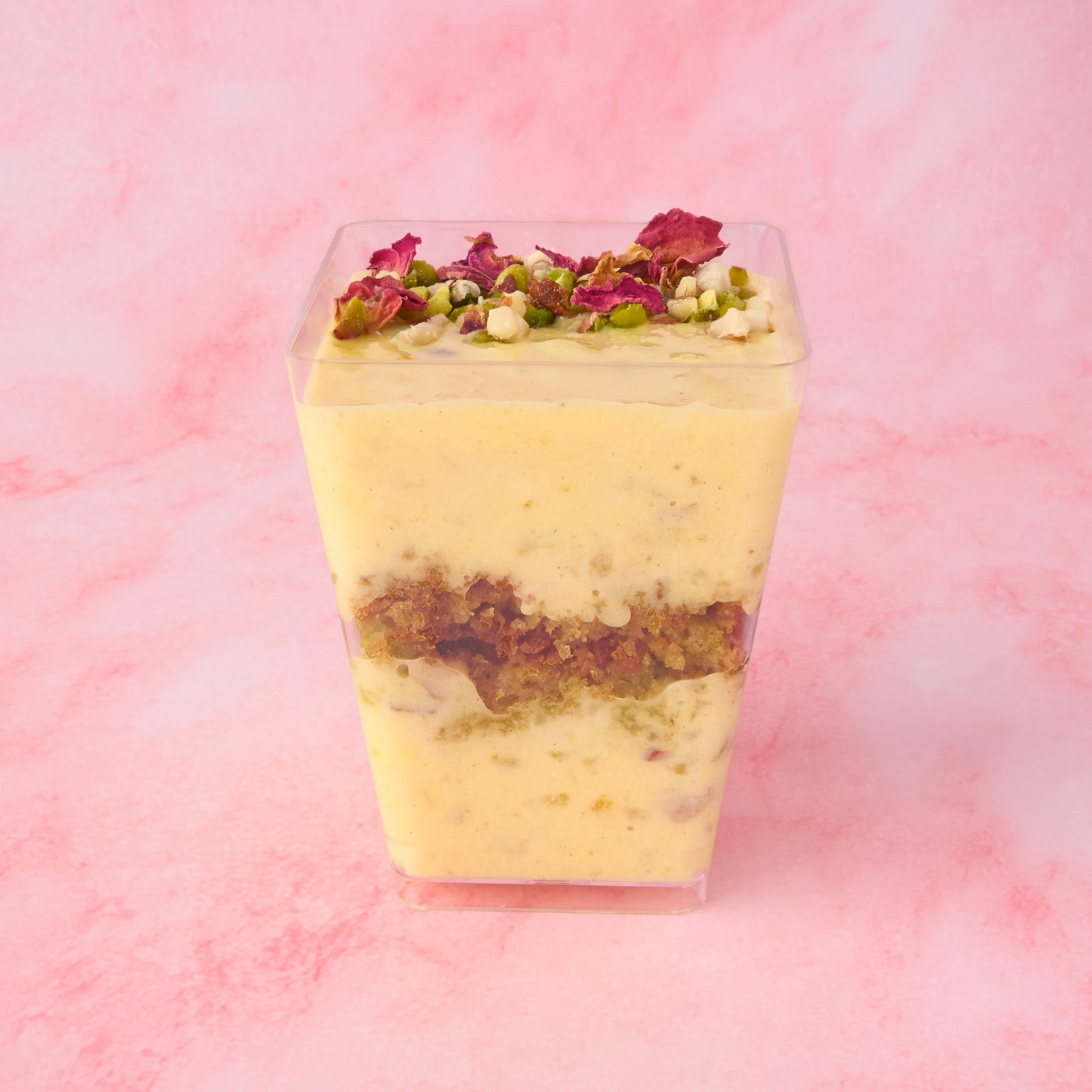 Layered Pistachio Kheer Trifle Cup in Sydney with visible rice pudding and pistachio cake crumble layers in clear dessert cup