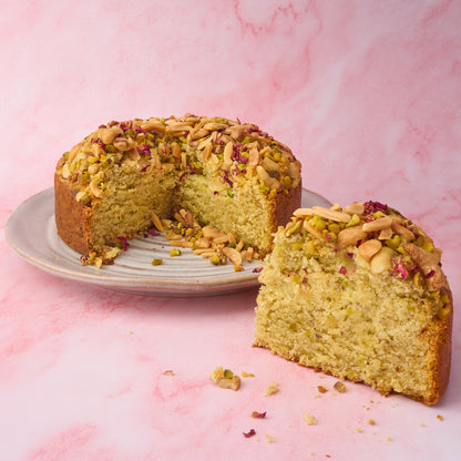 Inside view of eggless Pistachio Mawa Cake showing soft crumb and nut topping
