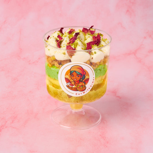 Layered rasmalai pistachio trifle cups with pistachio cake, mousse, rasmalai cream and rose petal garnish, served as individual Indian-inspired dessert cups in Sydney