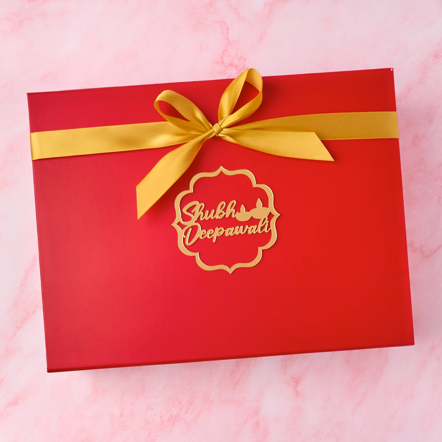 Red keepsake magnetic Diwali hamper box with golden ribbon and Shubh Deepawali charm