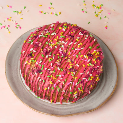 Eggless rose gulkand cake with colourful topping and moist texture, available in Sydney by EatWithSimer