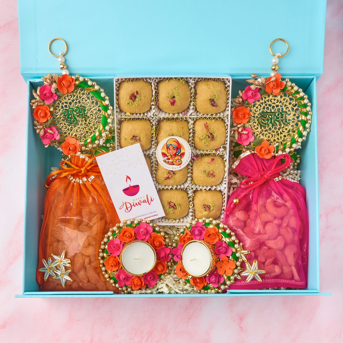 Shagun Diwali gift hamper with laddoos, roasted nuts, diyas, Shubh Labh decor and Diwali card